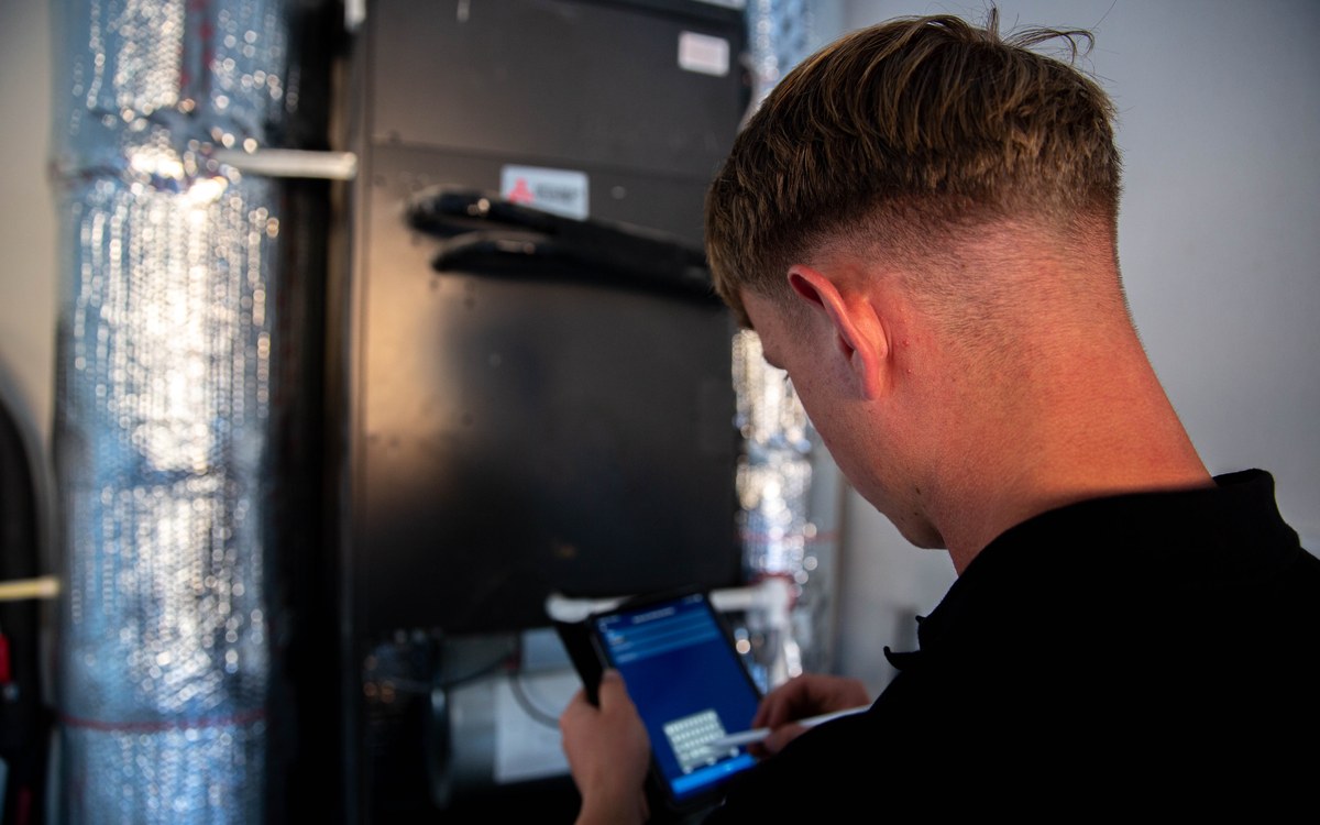 Sam Belza reviewing residential heating and cooling equipment