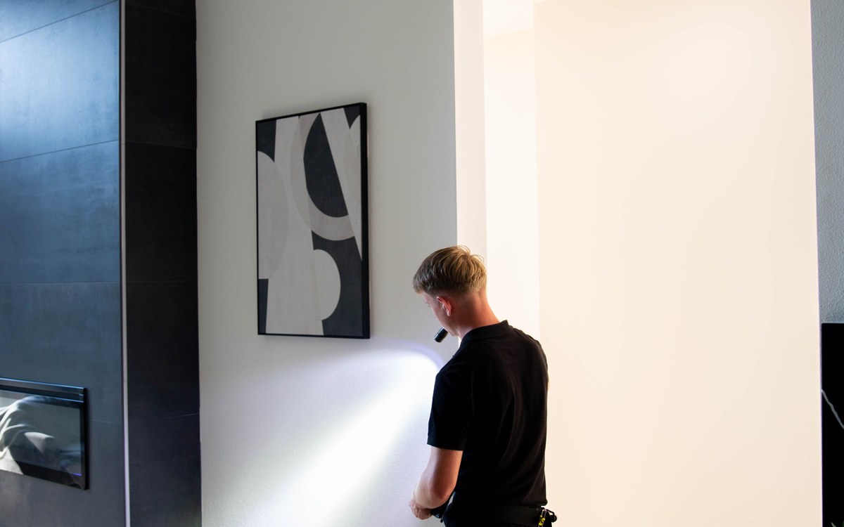 Sam Belza examining an interior wall before a home is listed