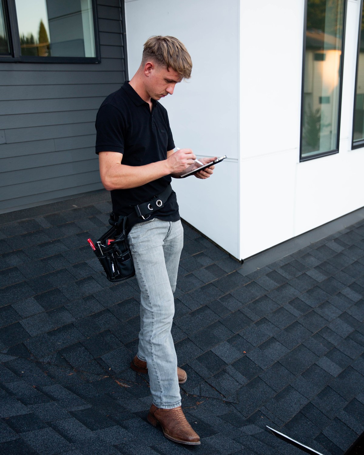 Sam Belza documenting roof conditions before a home is listed for sale