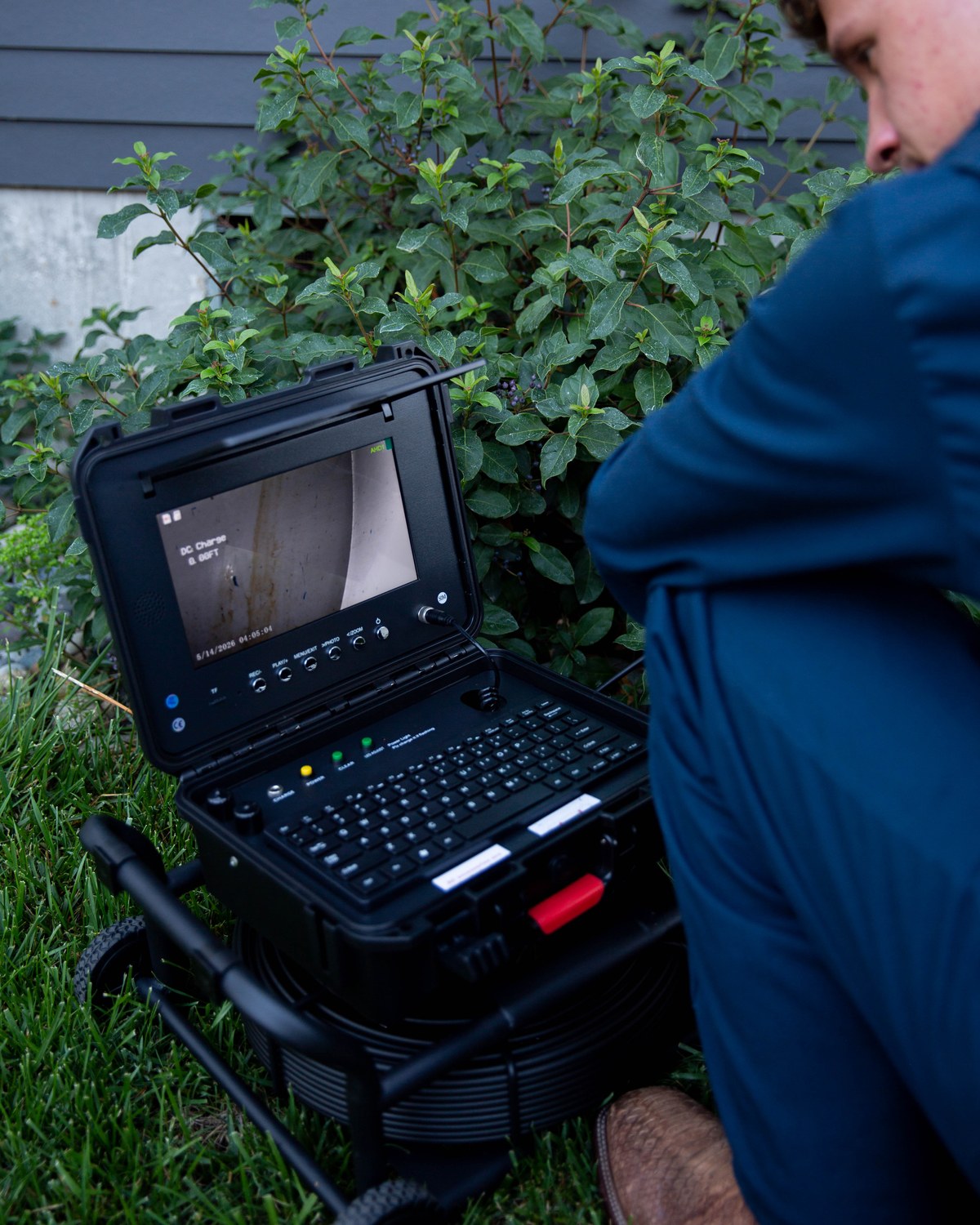 Close view of a sewer scope monitor displaying the inside of a residential line